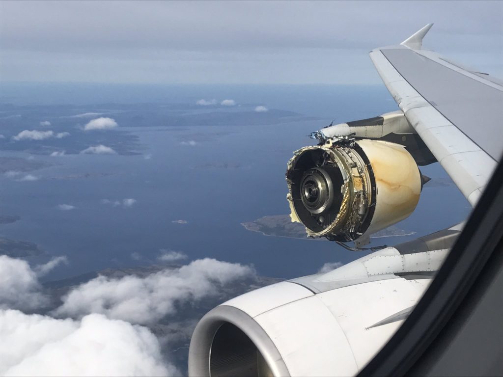 an engine of an airplane flying over the ocean