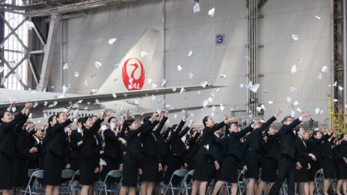 a group of women throwing paper in the air