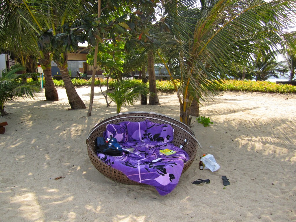 a purple blanket on a chair in the sand