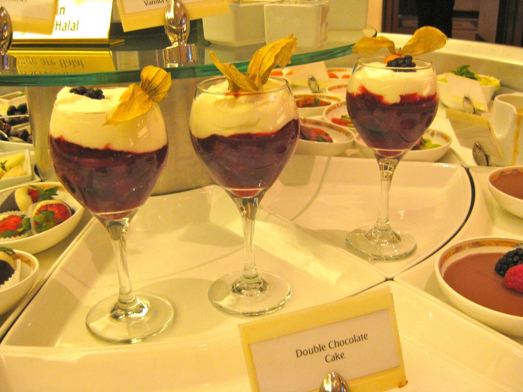 a group of glasses of desserts