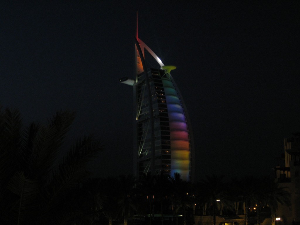 a tall building with colorful lights at night