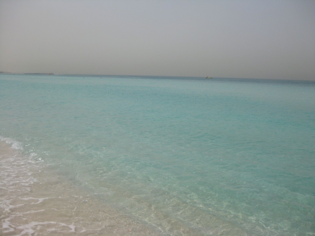 a body of water with a sandy beach
