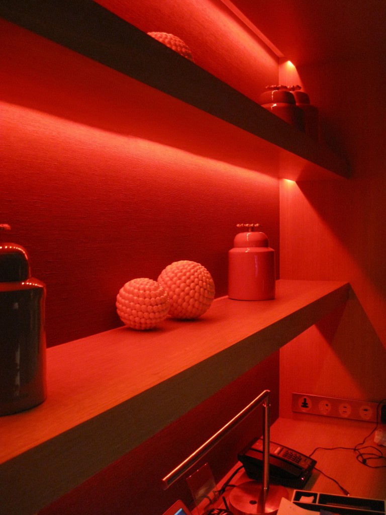 a shelf with red lights