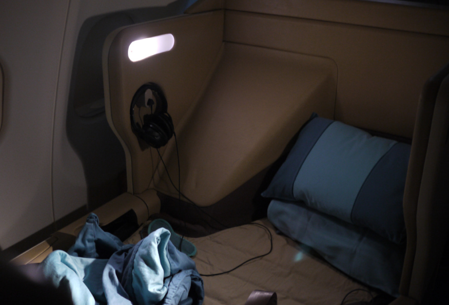 a bed with headphones and a blanket on it