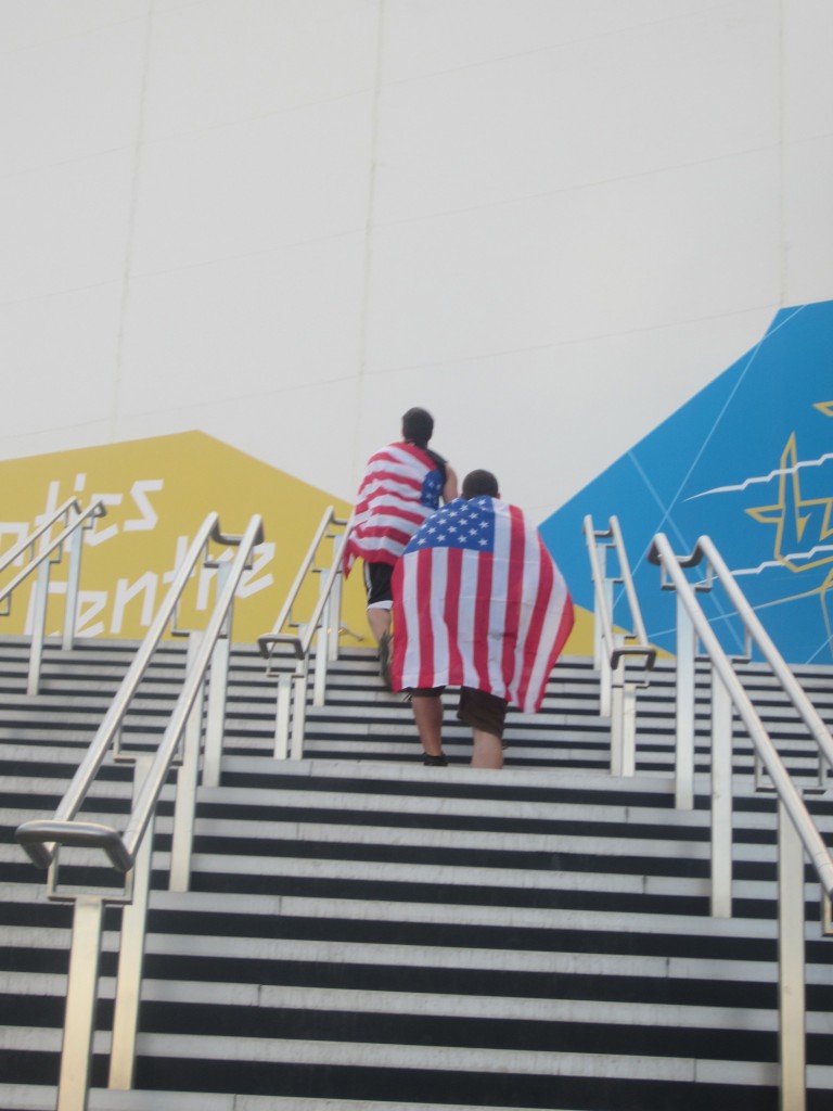 two people wrapped in american flag walking up stairs