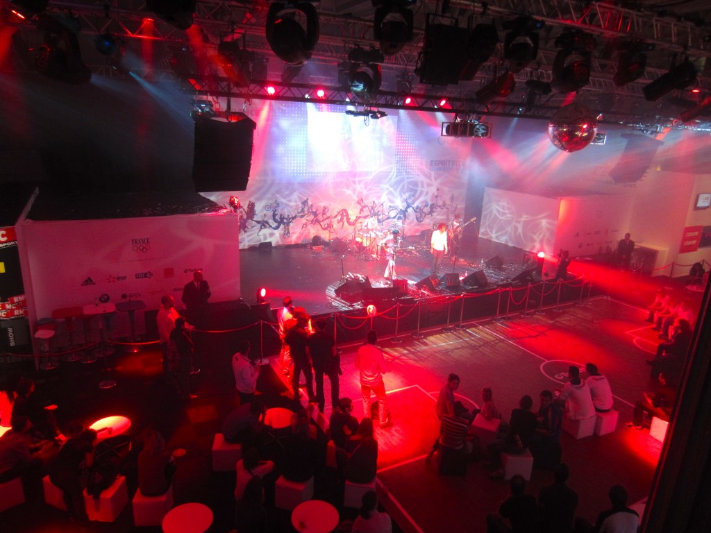a band on a stage with red lights