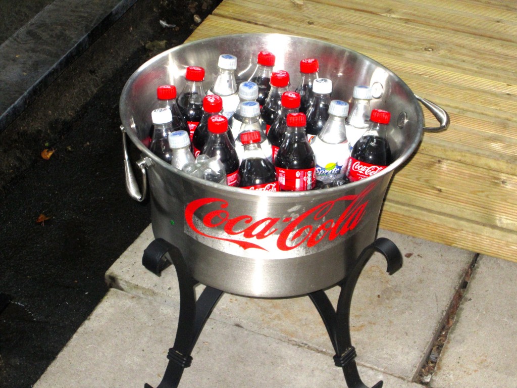 a large metal pot filled with soda bottles