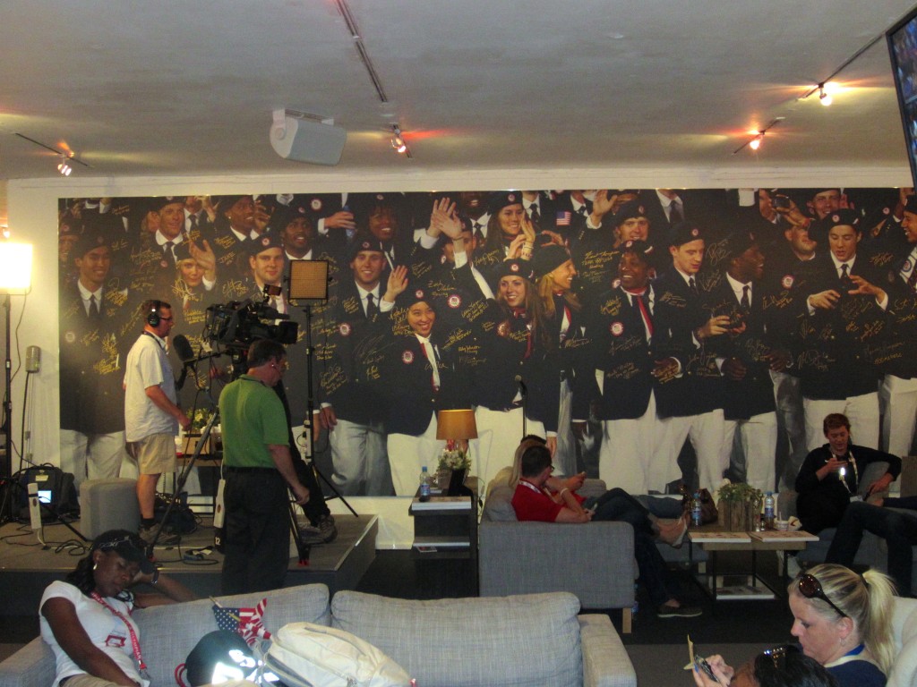 a group of people in a room with a large wall of people