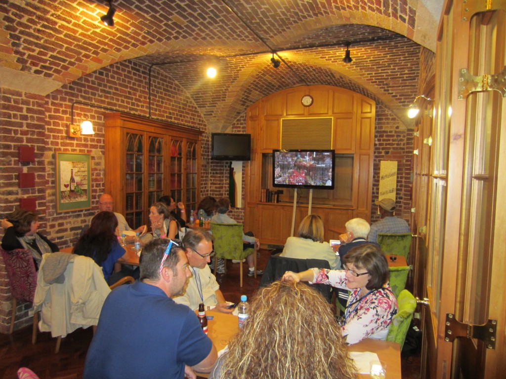 a group of people sitting at tables in a room with brick walls