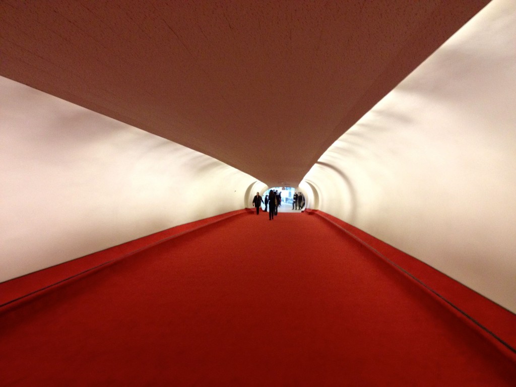 a red carpeted walkway in a tunnel