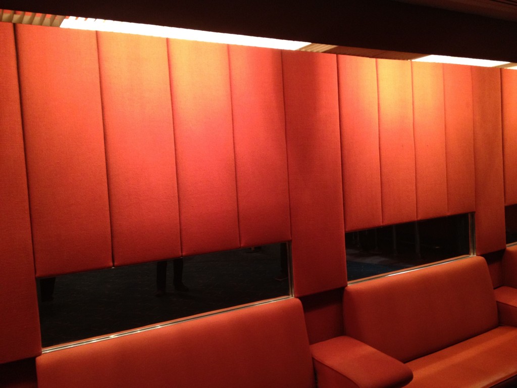 a red fabric wall with a mirror