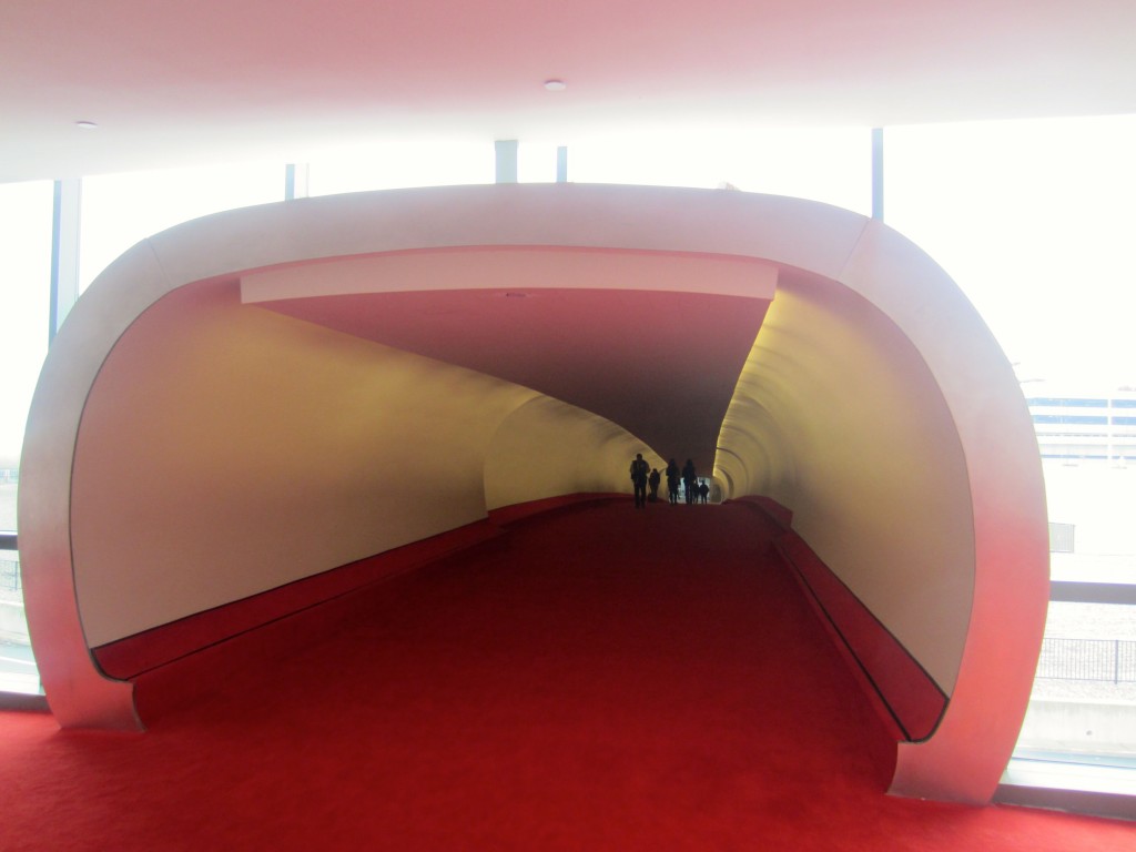 a red carpeted walkway with people walking
