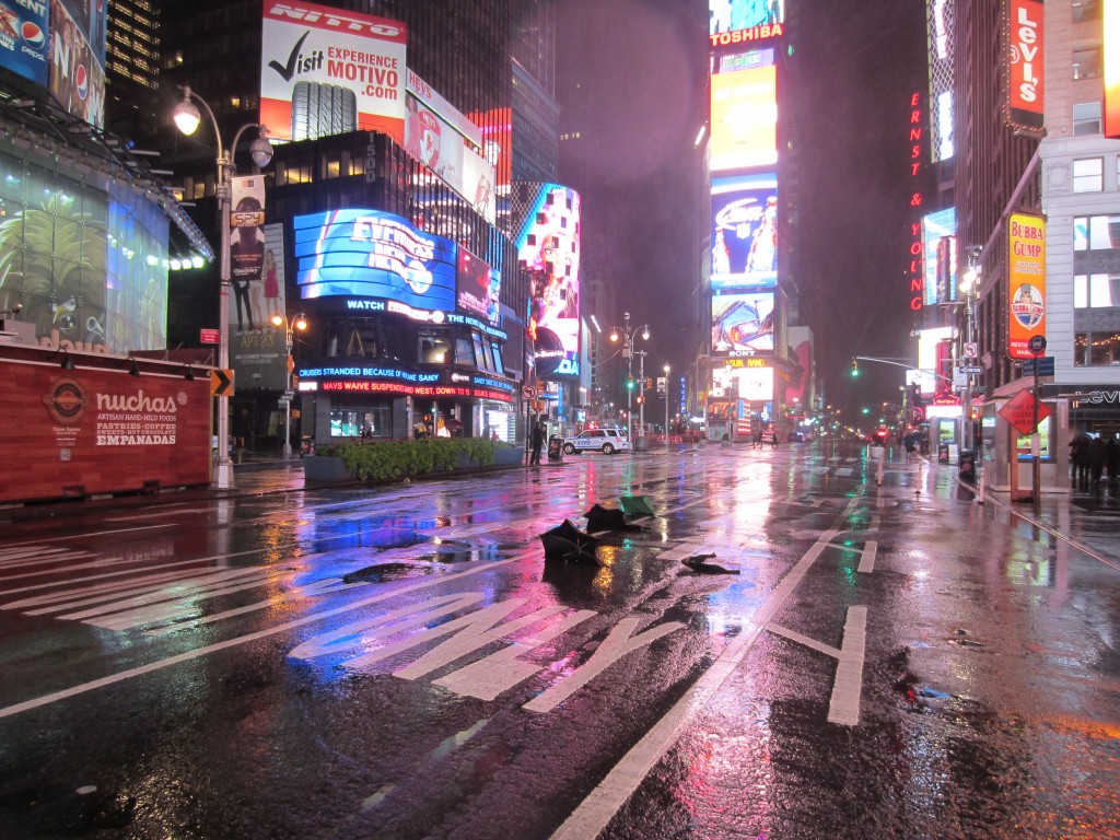 a wet street with buildings and signs