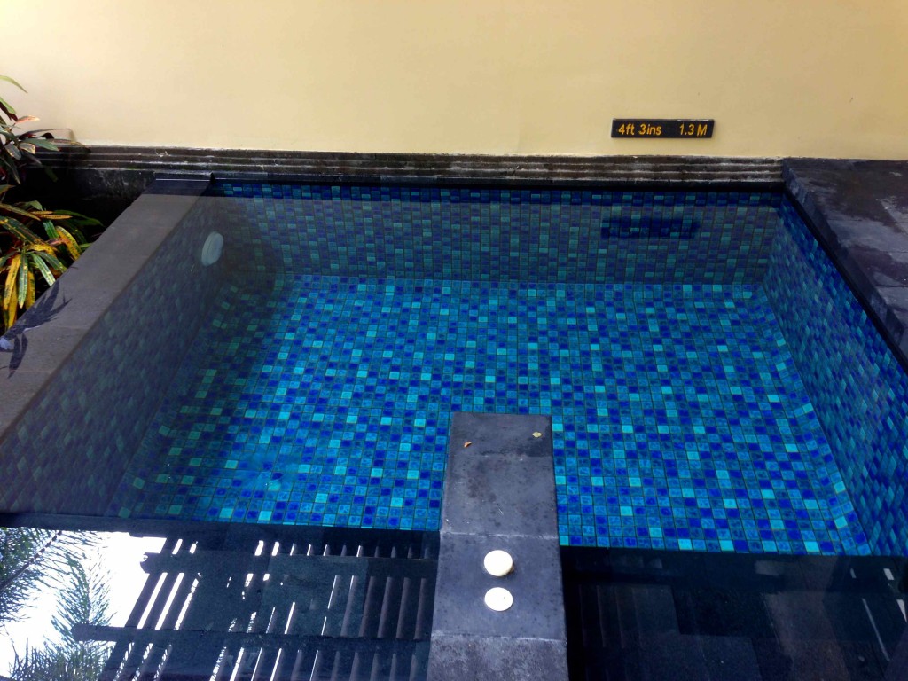 a small pool with blue tiles