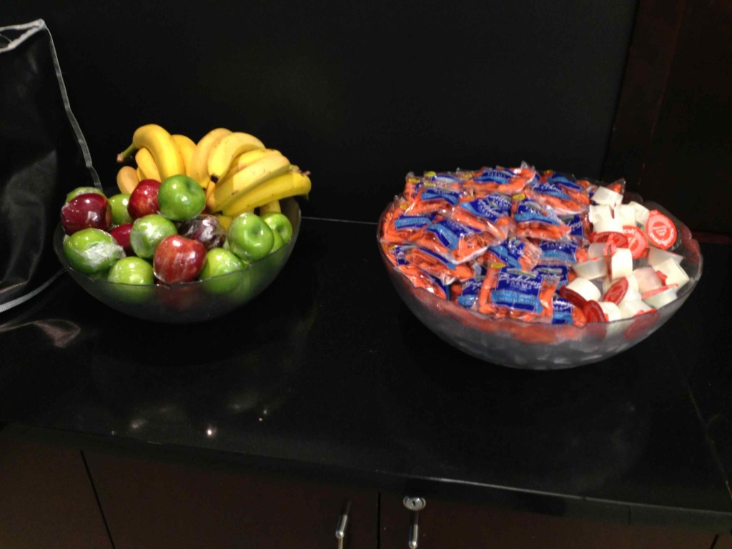 a bowl of fruit and candy on a counter