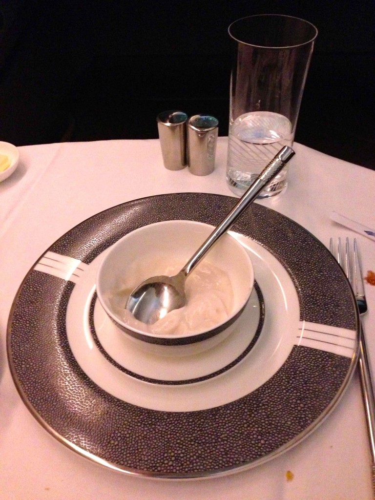 a bowl with a spoon on a plate