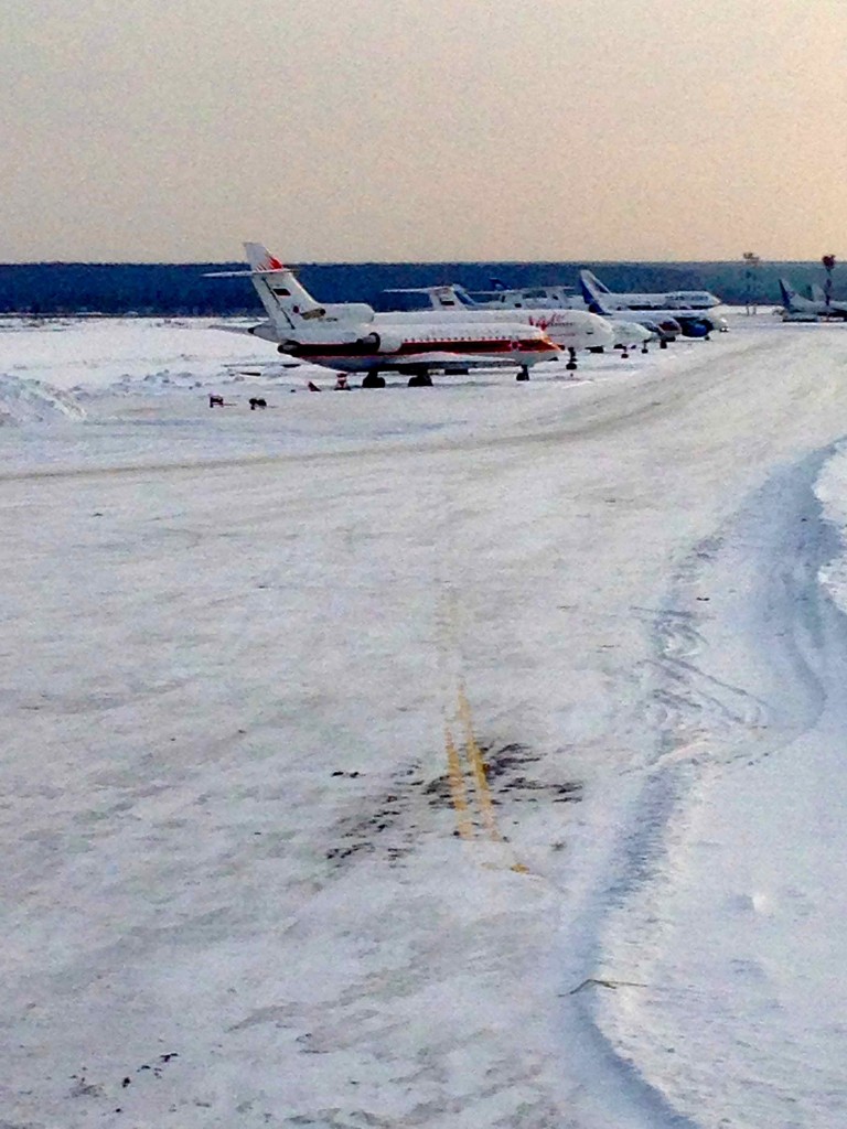 airplanes on a snowy runway