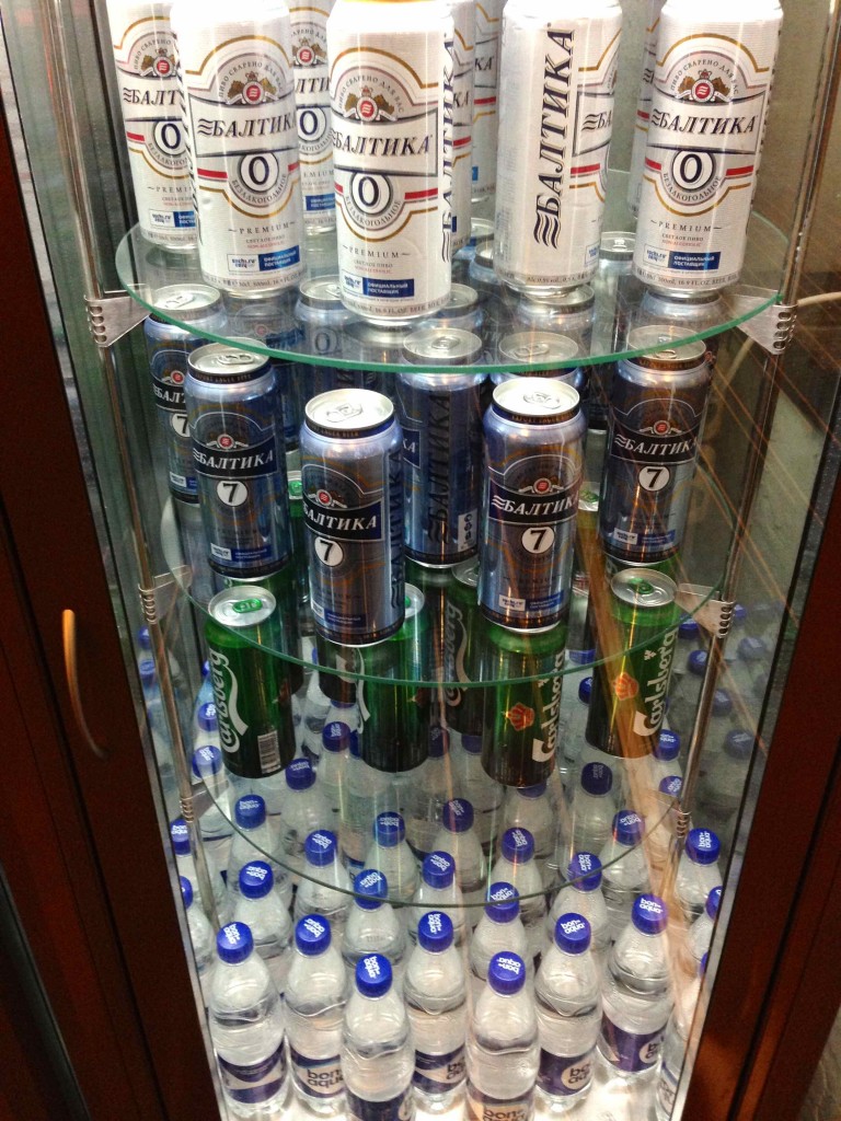 a glass cabinet filled with cans of beer