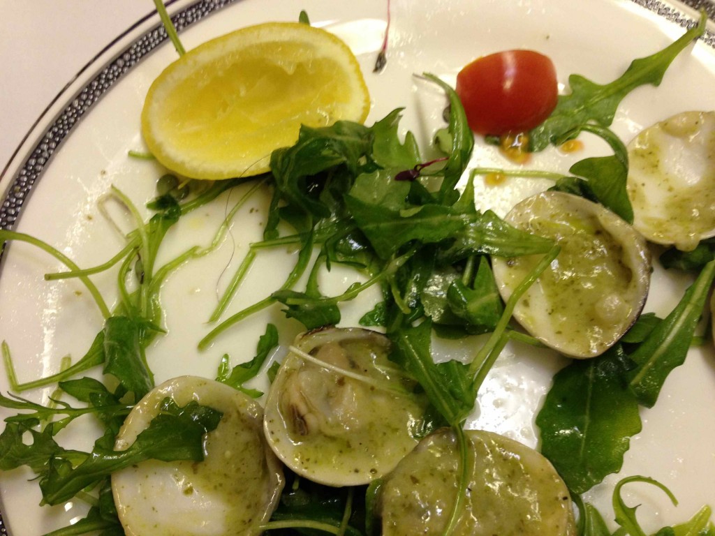 a plate of food with a lemon and greens