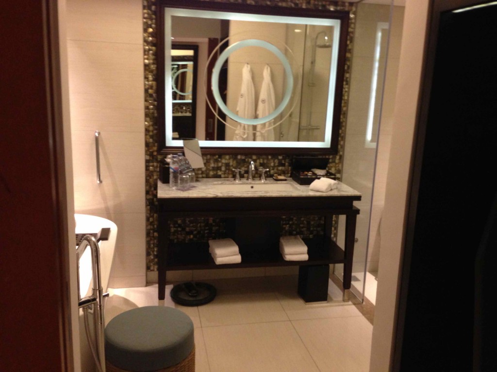 a bathroom with a mirror and towels