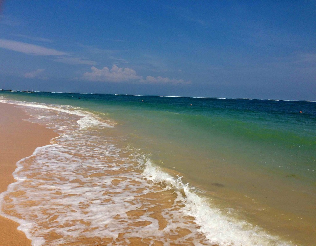 a beach with waves crashing on the shore