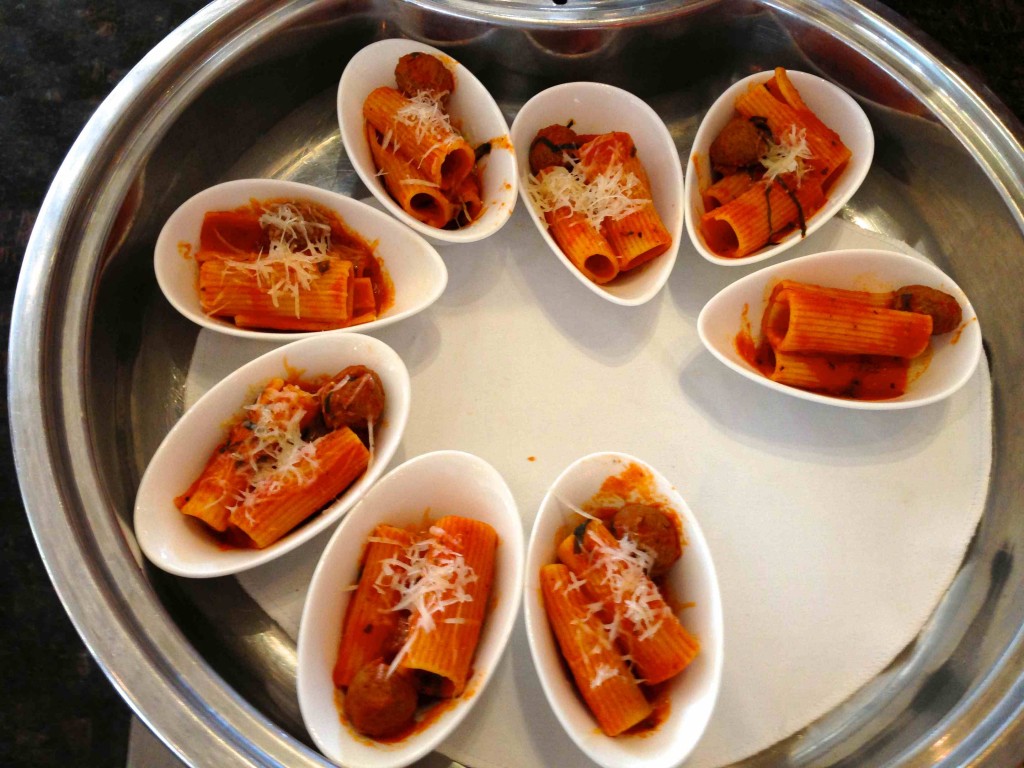 a plate of pasta with meatballs and cheese