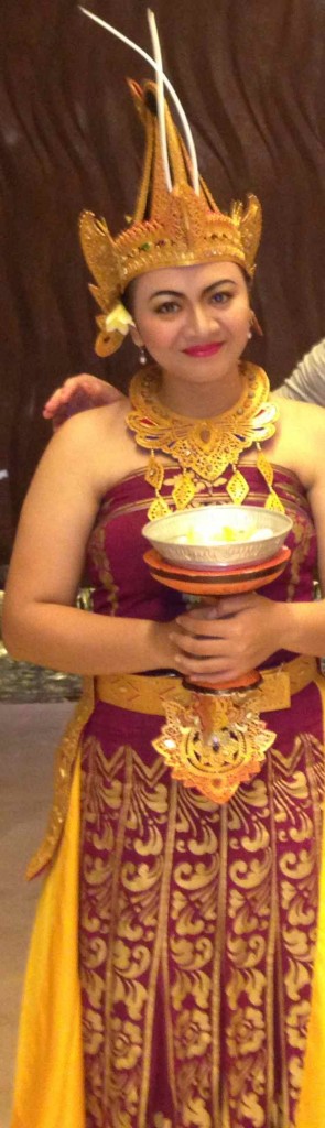 a woman in a purple dress holding a bowl of food