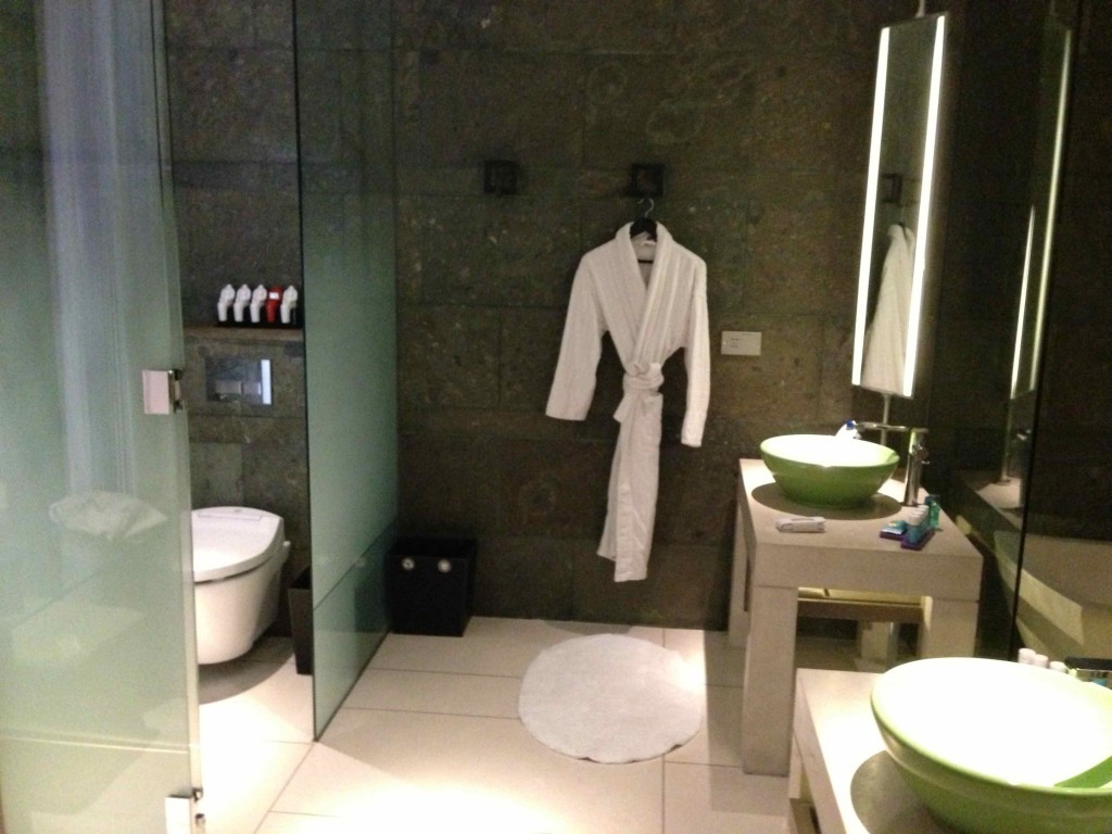 a bathroom with a white robe and sink