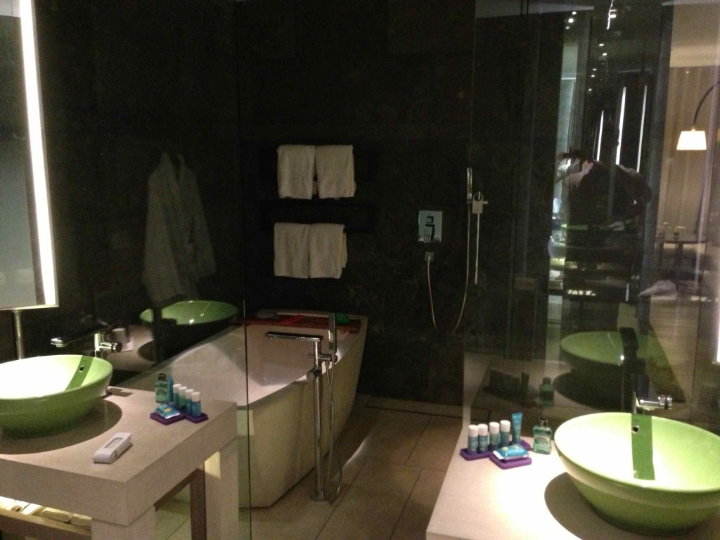 a bathroom with green sinks and a tub