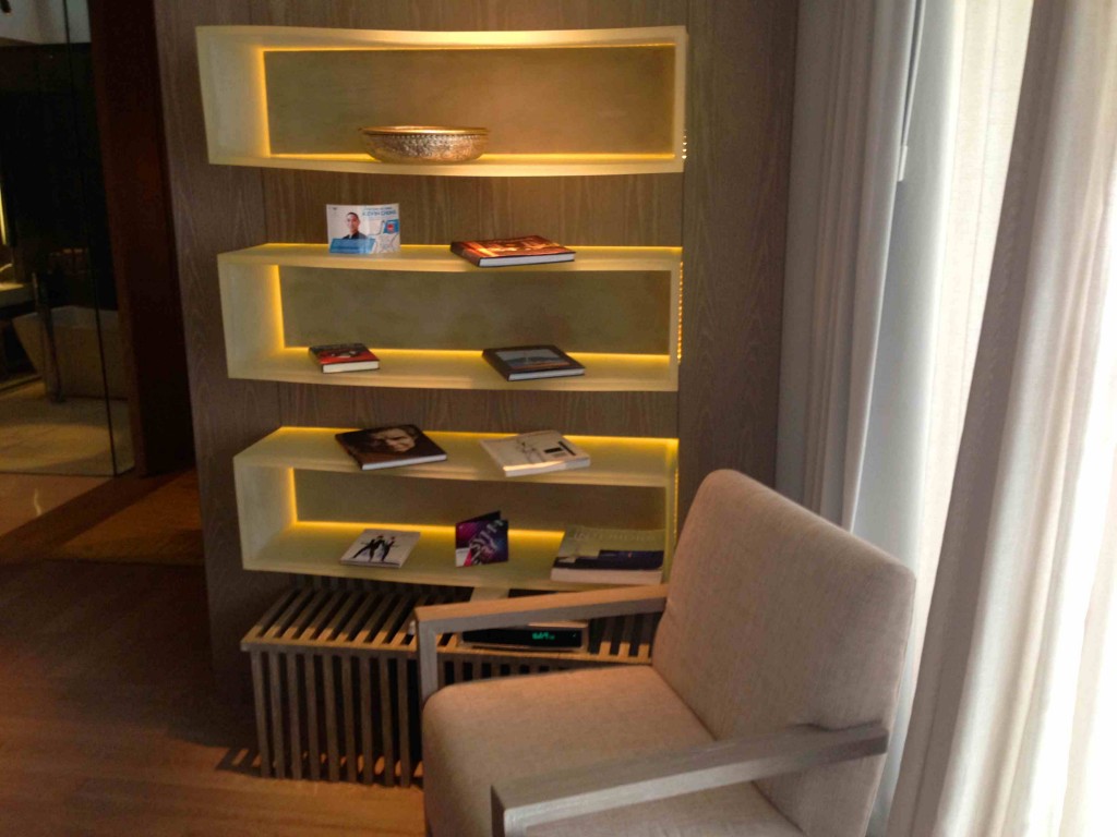 a chair and shelves with books