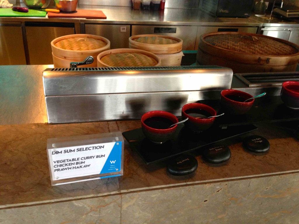 a counter with bowls of soup and a sign