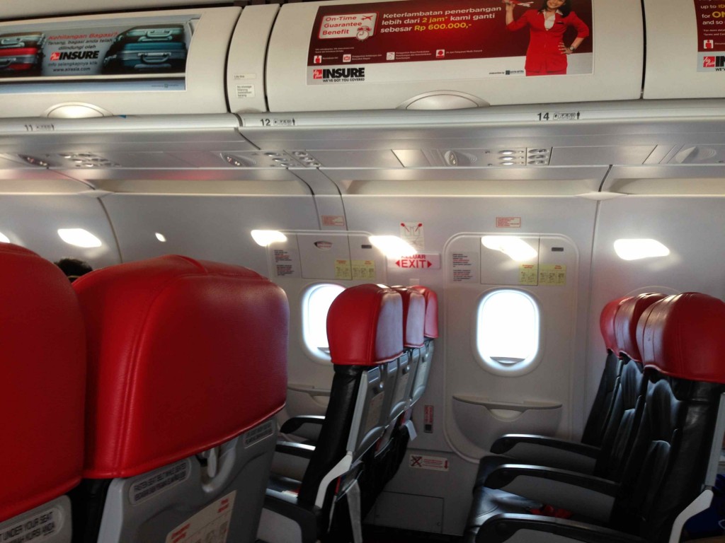 a plane with red seats and a sign