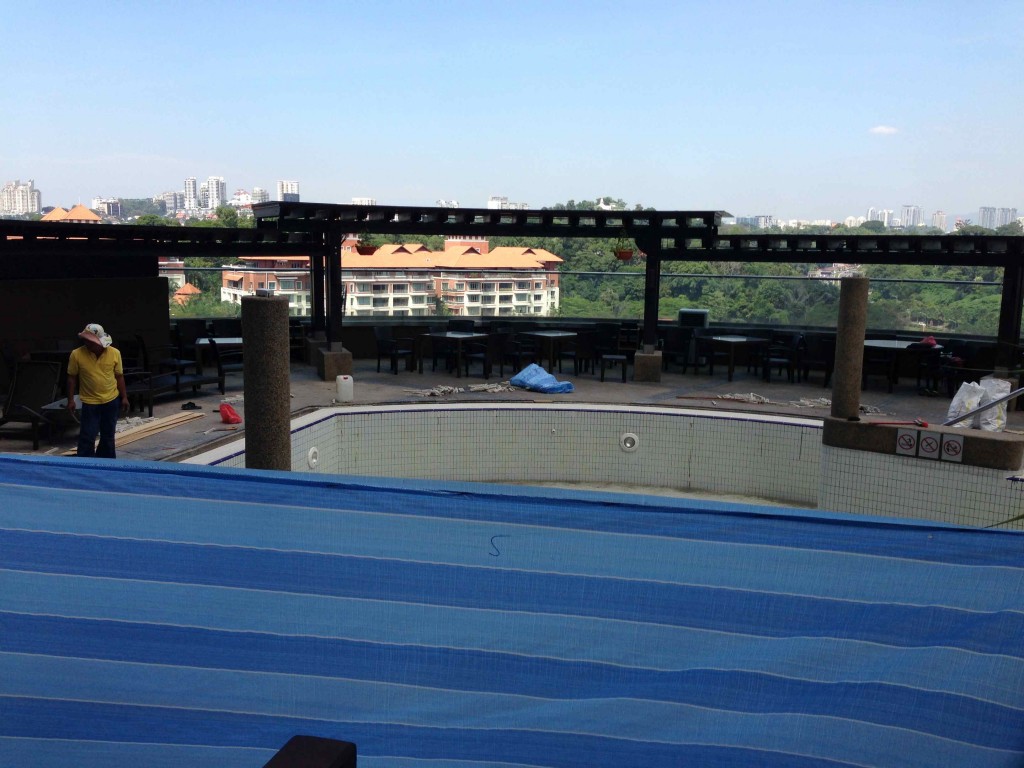 a pool under construction with a blue cover