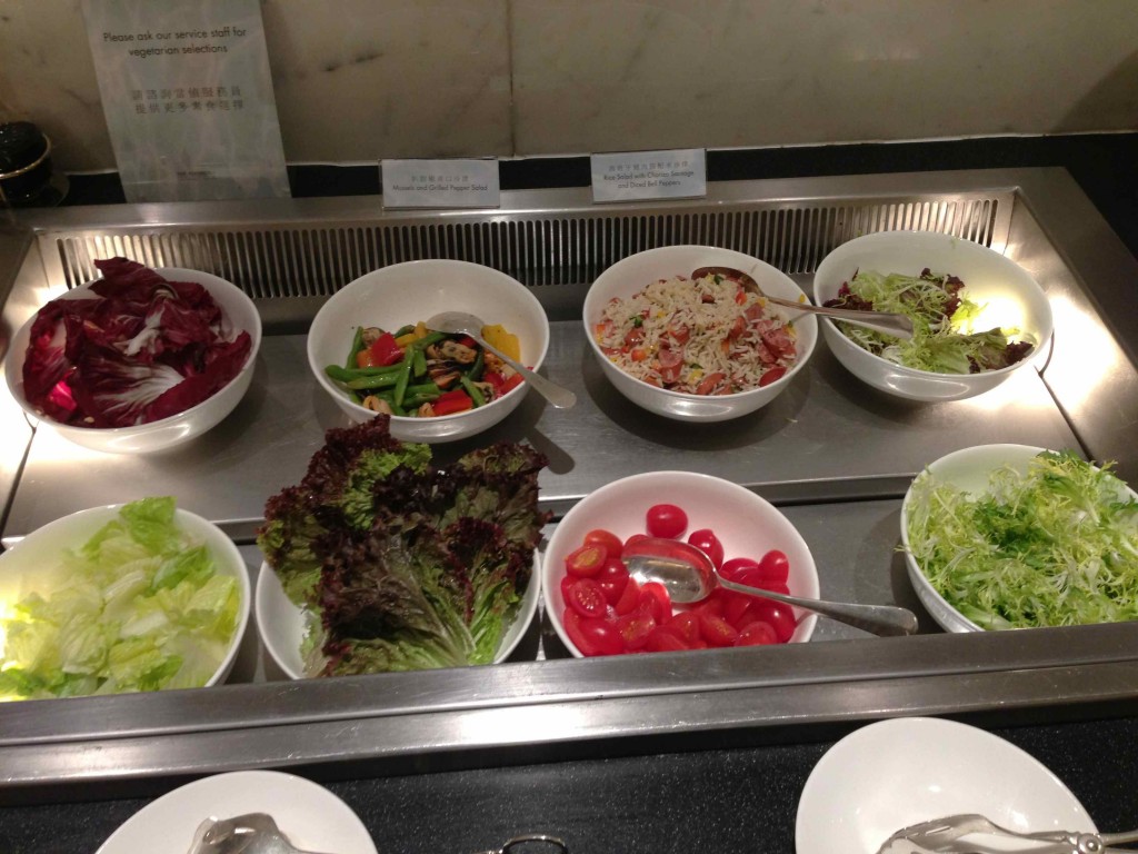 a row of bowls of salad