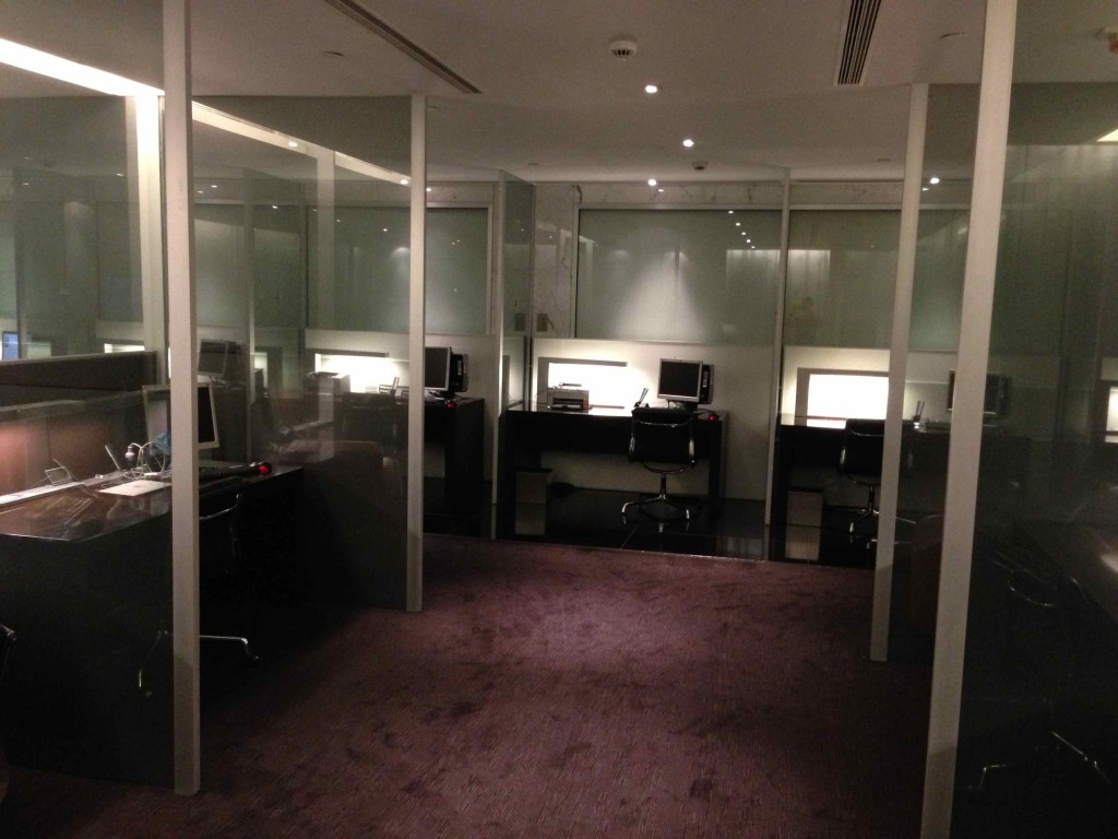 a room with glass walls and computers