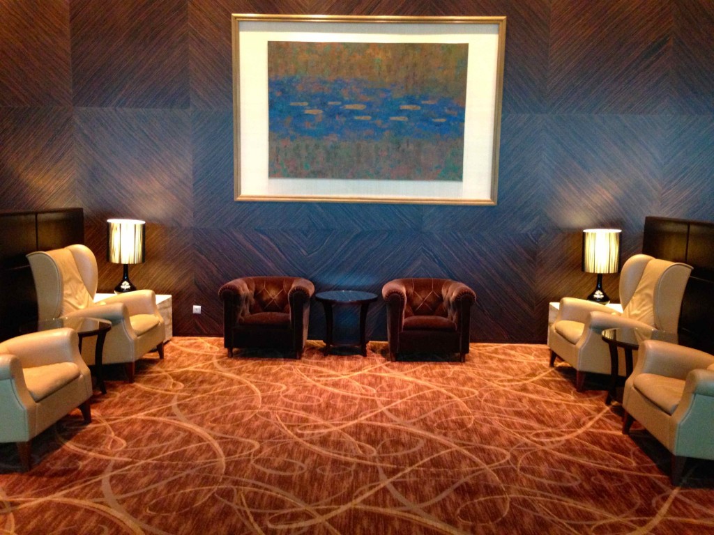 a room with chairs and a painting on the wall