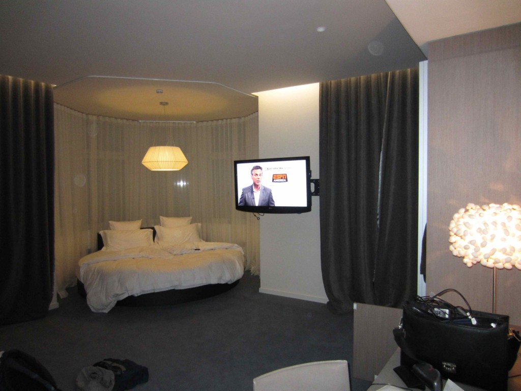 a bedroom with a bed and a tv