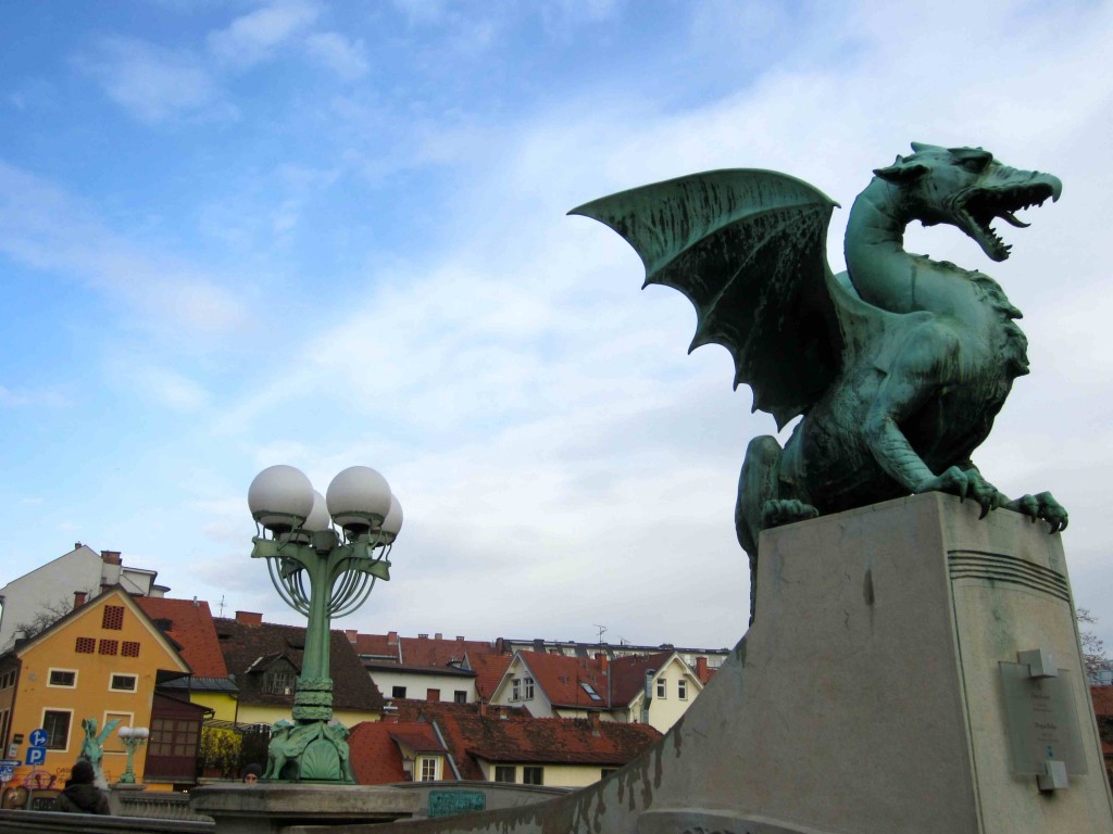 a dragon statue on a bridge