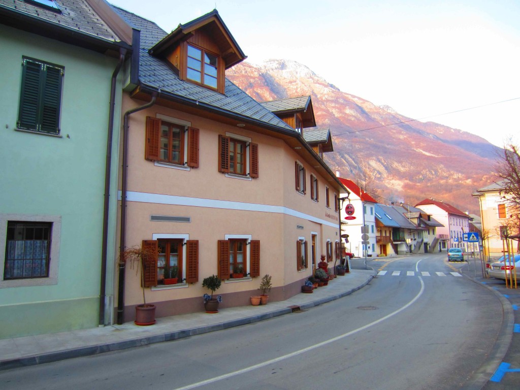 a street with buildings and mountains in the background