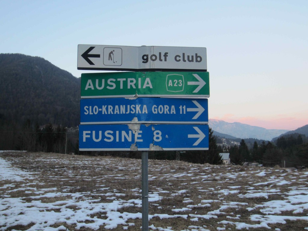 a sign post with several signs pointing to different directions