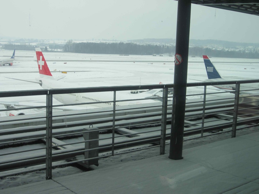 a snow covered airport with airplanes