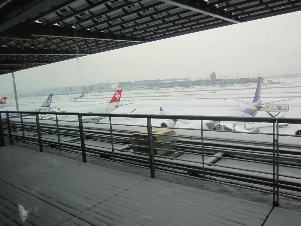 a group of airplanes in a snowy airport