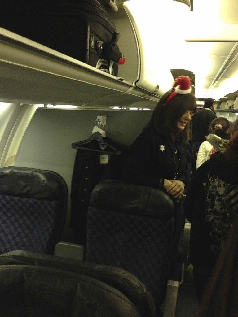 a woman wearing a red hat on an airplane