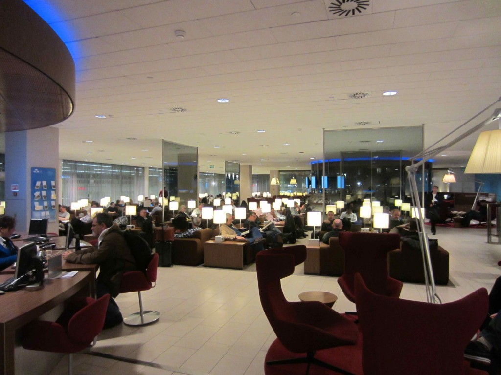 a group of people sitting in a room with lamps