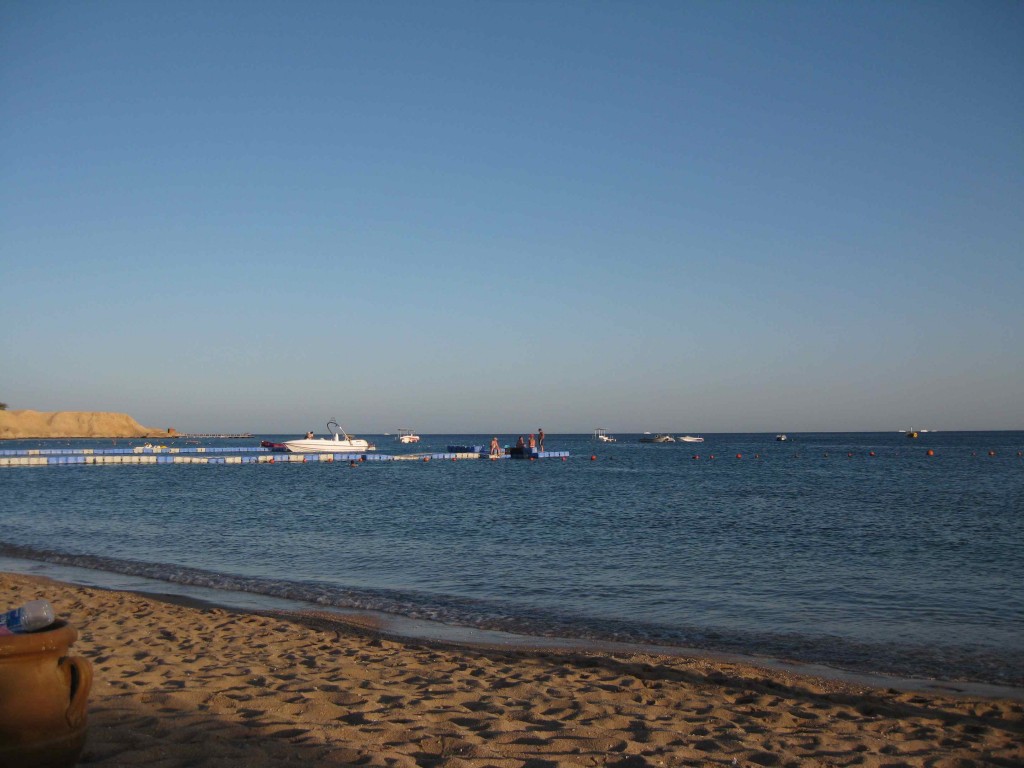 a beach with boats in the water