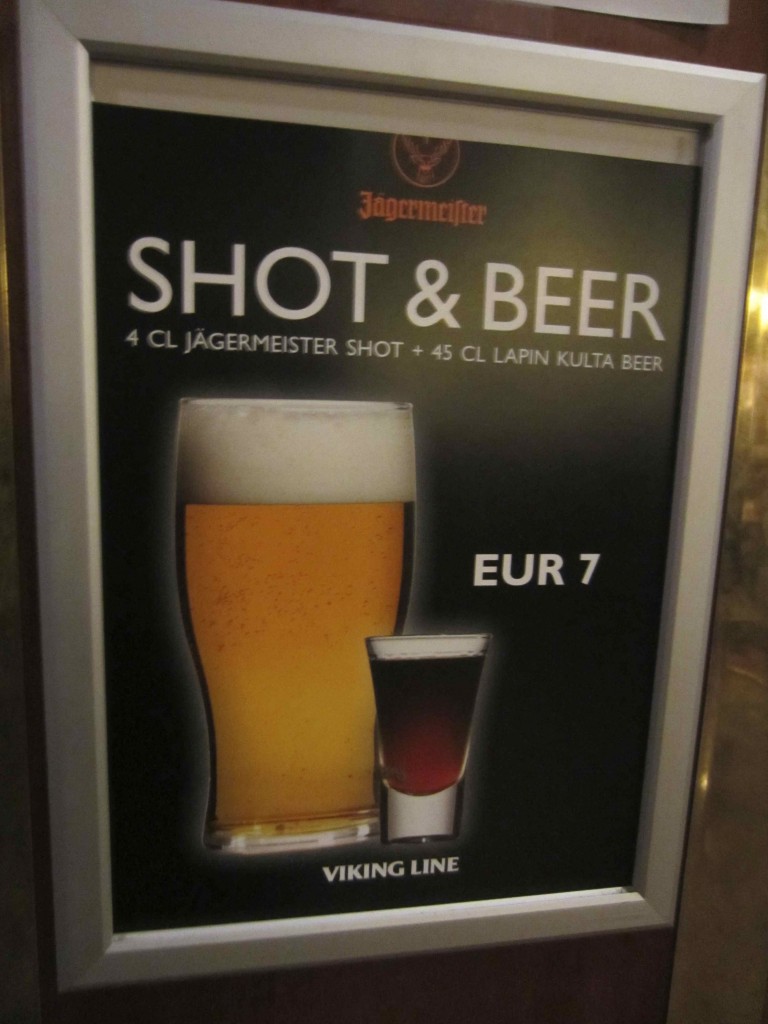 a sign with a picture of a glass of beer and a shot glass