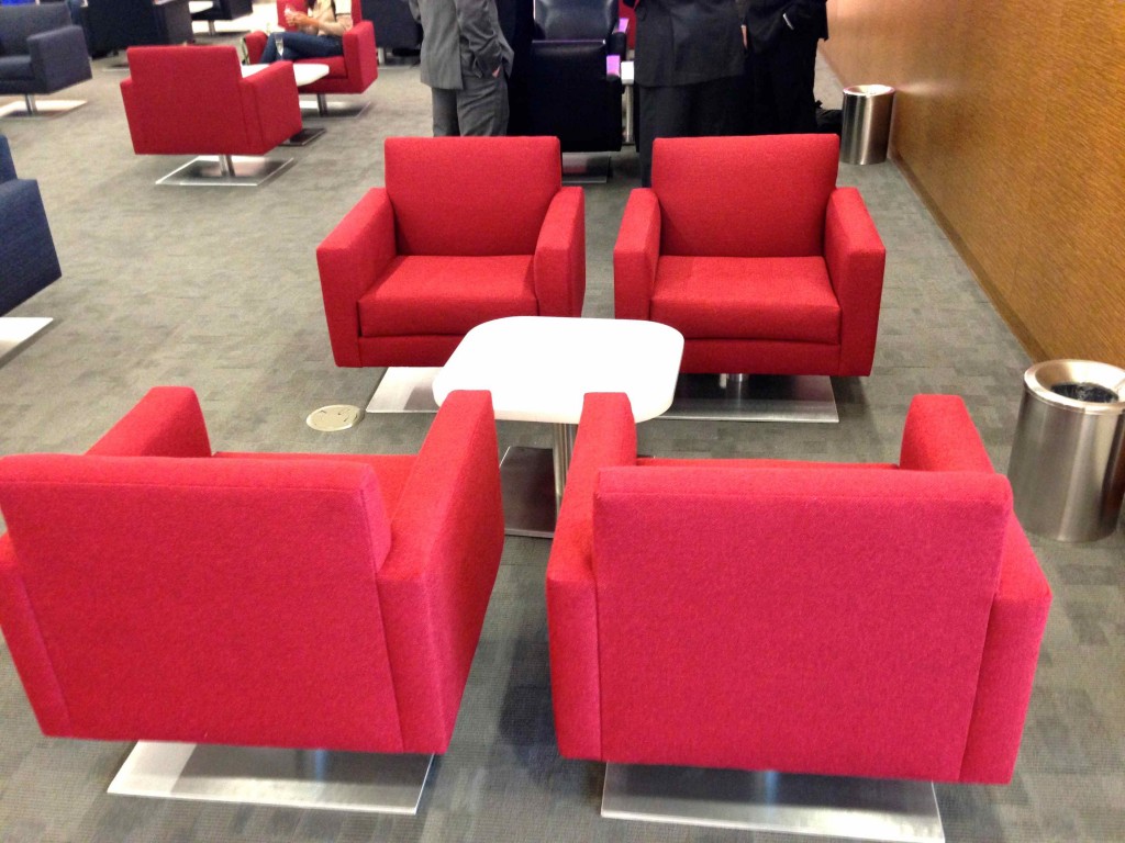 a group of red chairs and a table