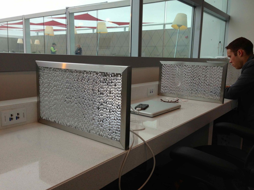 a pair of silver framed screens on a white counter