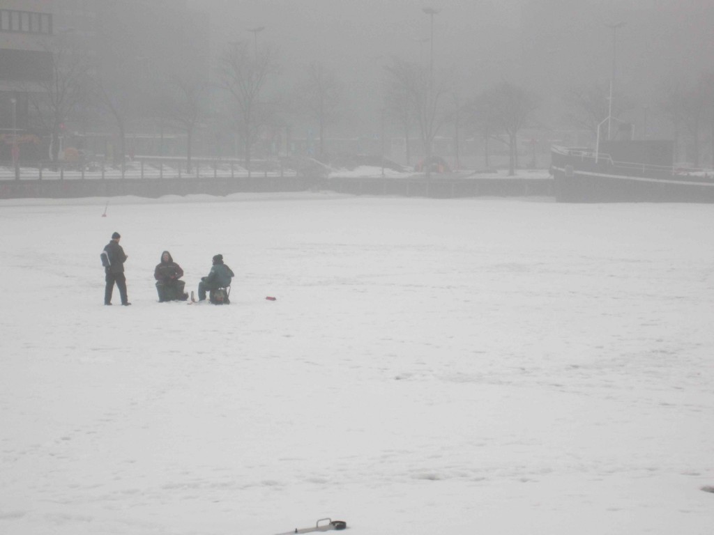people fishing on a snowy field