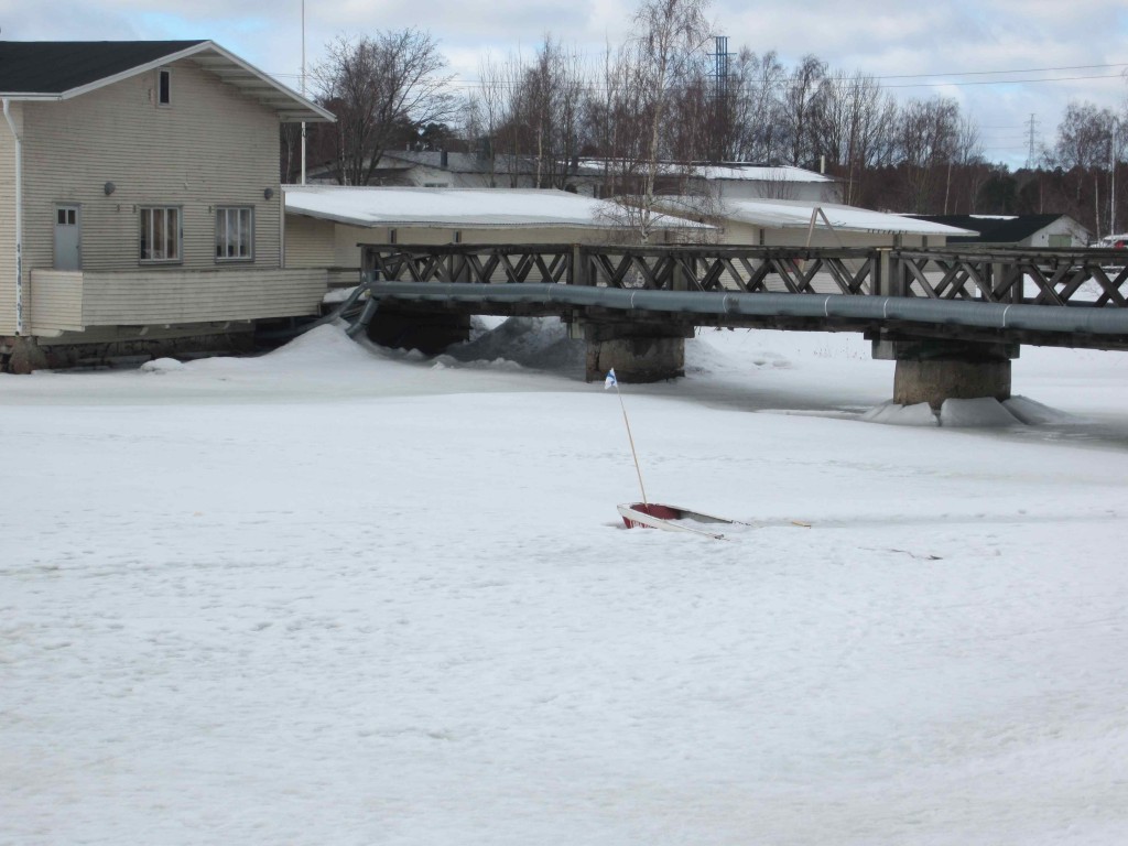 a bridge over a frozen lake